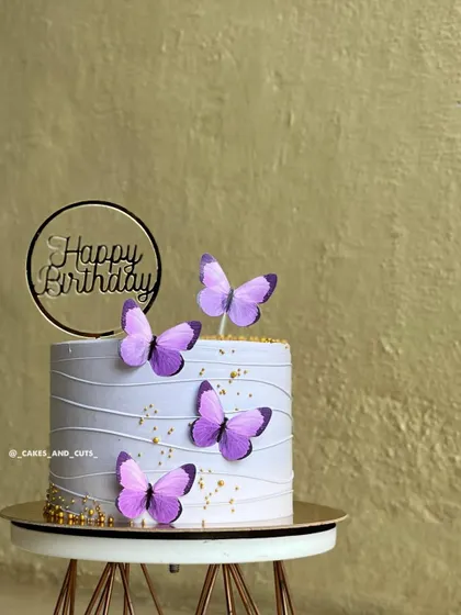 A closer look at the lavender butterfly cake, showing the delicate line work on the buttercream.