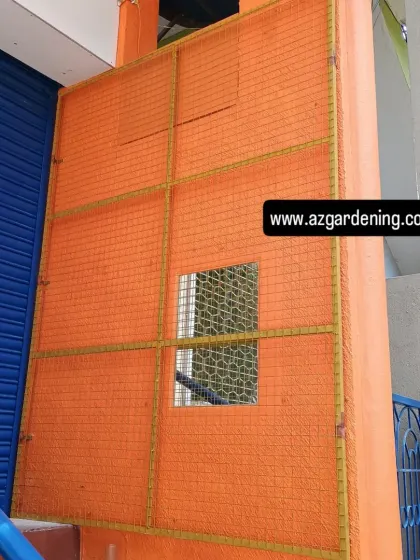 This is the starting point for a commercial entrance project. The image shows the bare orange wall with a metal grid frame I installed, ready for the vertical garden modules.