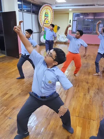 Young boys in a school workshop practicing the powerful arm movements and stances of Chhau dance.