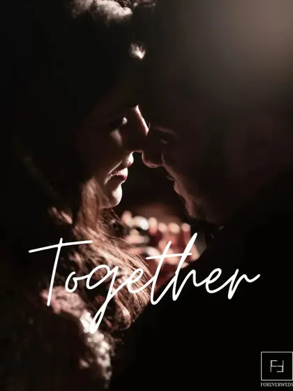 Together. A simple word for a profound feeling. This intimate, low-light portrait focuses on the closeness and connection between the couple, creating a deeply romantic and moody image.