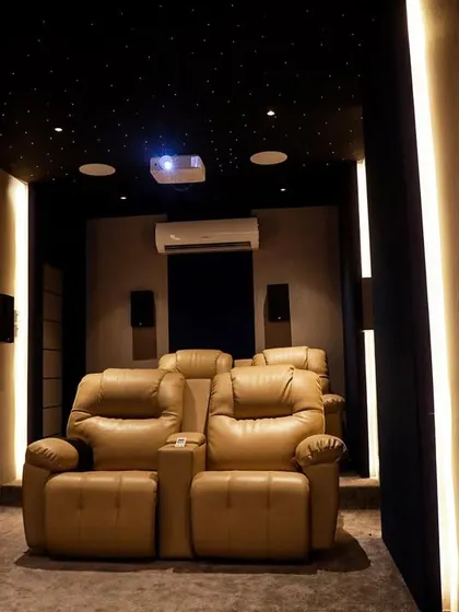 This wide shot shows the full layout of the compact theater, with its clean lines, simple color palette, and effective use of ambient lighting.
