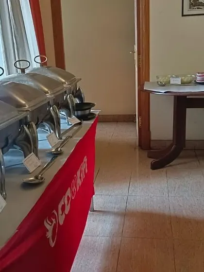 A buffet line set up in a home, with a separate table for desserts and drinks, showing a typical house party arrangement.