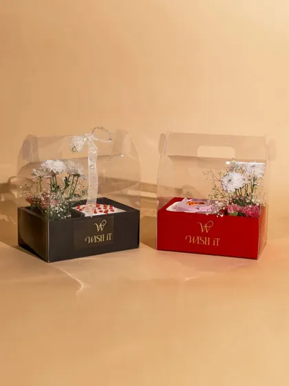 Our "Blossom & Bites" hamper is the perfect pick-me-up. It combines fresh, beautiful flowers with a delicious bento cake in a stylish, transparent box, making it a sweet and simple gesture of care.