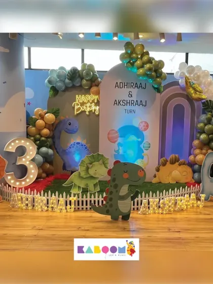 A roarsome dinosaur-themed birthday party! Our setup includes friendly dinosaur cutouts, a volcano, and a light-up number to celebrate a special third birthday.