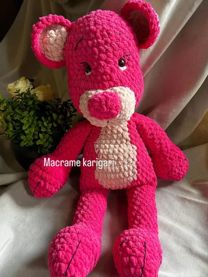 A full view of the handmade Pink Panther amigurumi toy. We paid close attention to his sly expression and iconic look. This is a great example of a custom character piece we can create for you.