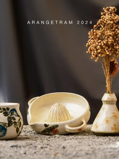 Ria, an artist inspired by nature, explores the botanical diversity of Kerala in her Arangetram collection. Her work features delicate flower paintings using underglaze on ivory clay, creating pieces that are filled with creativity and joy.