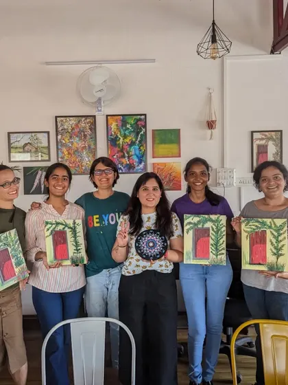 A group of proud artists with their finished rustic door paintings and dot mandalas. Everyone's artwork is unique and beautiful.