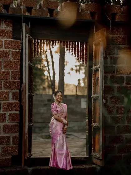 A beautiful bride framed by a traditional doorway. We use architectural elements and natural light to create artistic and striking portraits that highlight her grace.