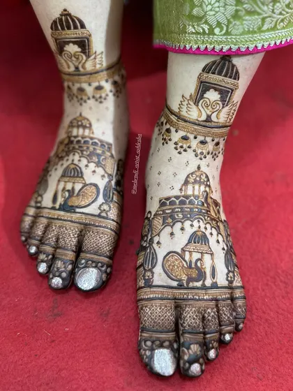 A close-up of the royal bridal feet design. This image highlights the detailed work on the palanquins, peacocks, and swans.