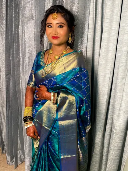 The full look, including the messy braid adorned with traditional gold accessories.