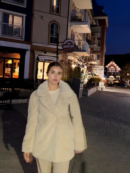 Celebrating my birthday with a night out in Blue Mountain village, wearing a cozy cream-colored coat.