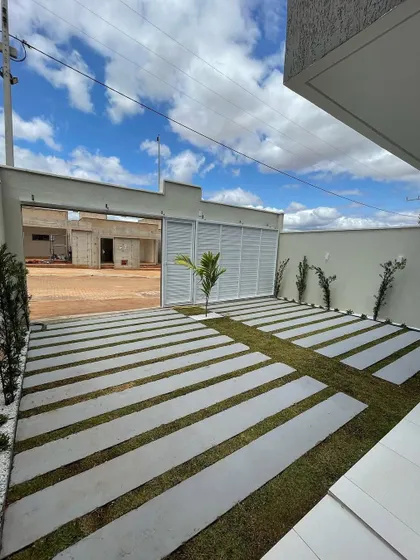 Another example of our modern walkway and driveway designs. The linear pattern of the pavers guides the eye towards the house, while the surrounding plantings soften the edges and add a touch of green.