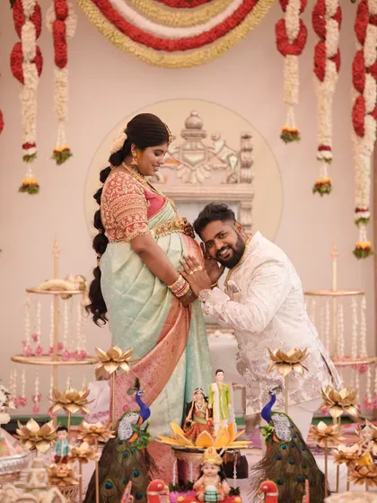 A heartwarming moment between the expecting couple. The mother-to-be is wearing our custom pink embroidered blouse with her pastel saree.