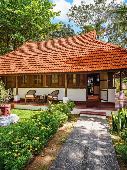 The Ambara Mana cottage, surrounded by a vibrant garden. This 73-year-old heritage home provides a naturally cool and comfortable retreat, even during warm summer months.