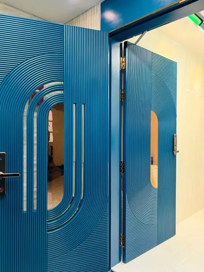 A closer look at the stunning blue PU-finished safety door, showing how the double-door design comes together. The fluted texture and curved lines make it a true work of art.