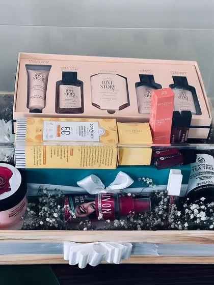Another view of the acrylic box trousseau, showcasing products from The Body Shop and other luxury brands, all nestled in a bed of baby's breath.