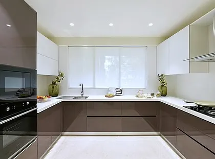 Another view of the sleek modular kitchen at the Bellevue project. The layout is designed for an efficient workflow, with the oven, microwave, and cooktop all within easy reach.