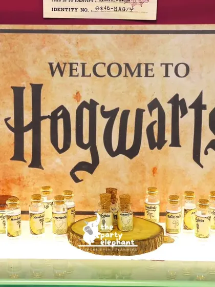 Welcome to Hogwarts. For this Harry Potter themed party, I set up a welcome station with a custom sign and tiny 'potion' bottles as party favors for the young witches and wizards.