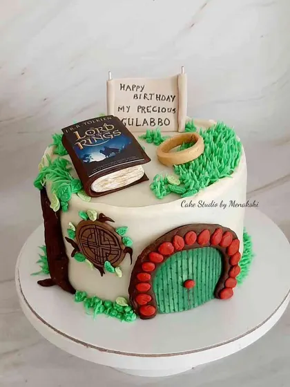 A Lord of the Rings themed cake featuring the iconic hobbit door and the One Ring. This is a perfect design for any fan of J.R.R. Tolkien's epic fantasy.