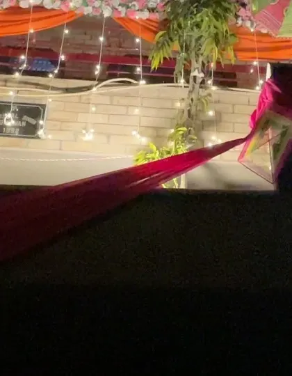 A detail shot of the house facade decoration, showing the layers of colorful drapes and lights.