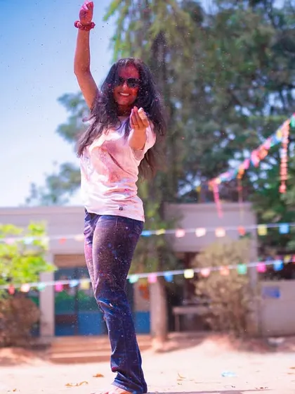 Raising a hand in celebration. My choreography includes simple, powerful moves that make everyone feel like a part of a massive, synchronized dance group.