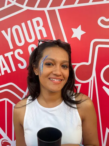 Another shot of the smiling client and her blue glitter art. It's all about creating looks that make people happy.