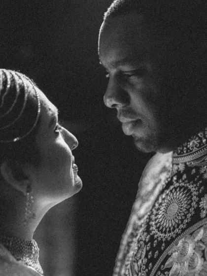 A powerful black and white close-up, capturing the intense and loving gaze between the couple during their Sangeet.