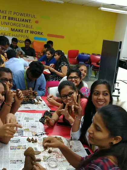 The sound of laughter is the best background music in my studio. Here's a corporate team taking a much-needed creative break, getting their hands messy and making clay Ganeshas together.