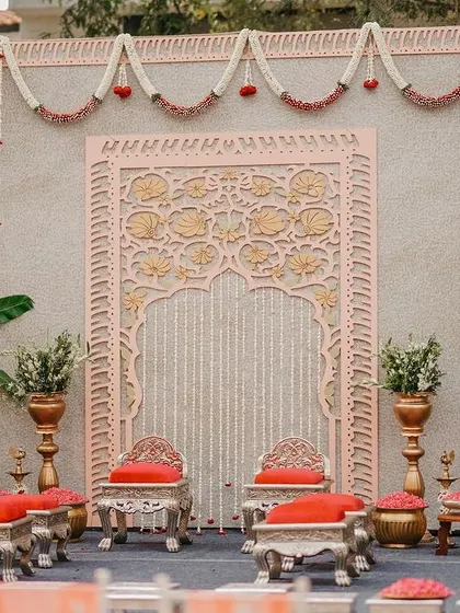 The elegant engagement stage, ready for the ceremony, with its blend of traditional Indian motifs and a soft, modern color palette.