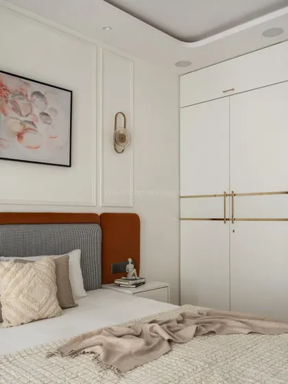 Another view of the wardrobe and bed, showing how the clean lines of the furniture contrast with the soft textures of the bedding, creating a balanced and harmonious design.