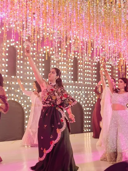 A graceful, synchronized pose from a large group performance. Even with bigger groups, I create routines that are easy to follow and result in beautiful, picture-perfect moments like this one.
