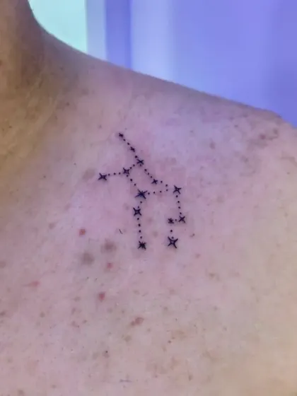 A constellation tattoo on the shoulder. We carefully map out the stars to ensure accuracy for the specific zodiac sign or celestial pattern the client wants.
