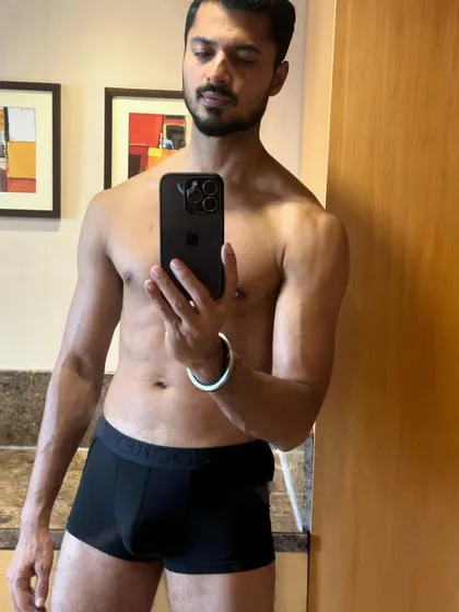 A relaxed but confident pose, showing the results of honest, hard work in the gym.