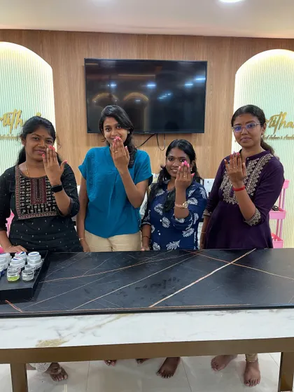 Proud students showing off the nail art they created on their own hands.