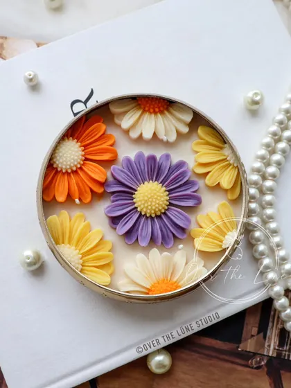 This new Daisy Urli design features a lovely mix of pastel orange, purple, and yellow. The cottagecore vibe is perfect for adding a touch of handmade charm to your home decor.