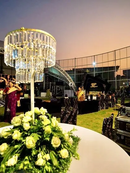 The overall ambiance of the outdoor venue. I used elegant table centerpieces with crystal chandeliers and professional DJ equipment to transform the space.
