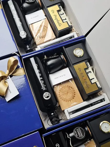Bespoke corporate gift hampers for the faculty at BMS Institute, containing a personalized bottle, desk calendar, and other useful items.