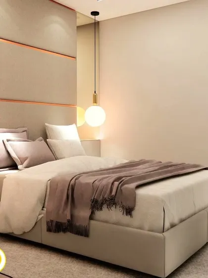 A close-up of the bed, showing the soft textures and warm lighting.