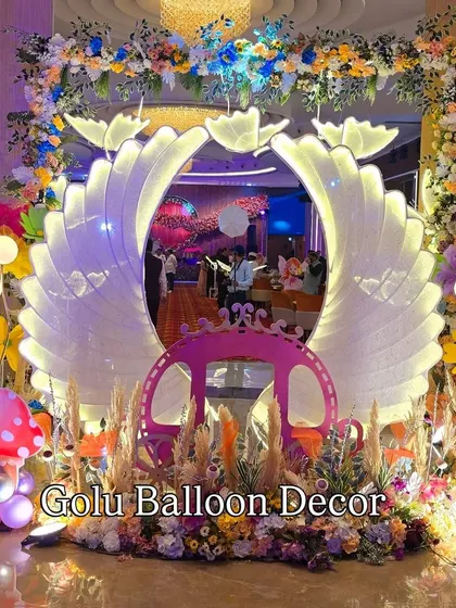 A closer look at the magical butterfly wing entrance, showing the intricate lighting and surrounding floral and pampas grass decor.