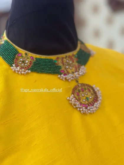 A blouse designed with a choker-style neckline that mimics the look of a necklace, showing another way I create built-in accessories.