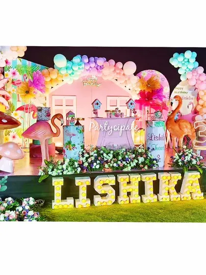 Let's flamingle! Lishika's flamingo-themed party was a vibrant and tropical celebration. The full stage setup featured large flamingo and mushroom props, marquee letters, and a colorful balloon arch.