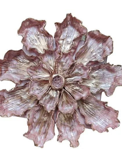 A single, large 3D flower sculpture with metallic pink and gold finishing. The petals are intricately layered and textured to catch the light, making it a stunning, standalone statement piece.