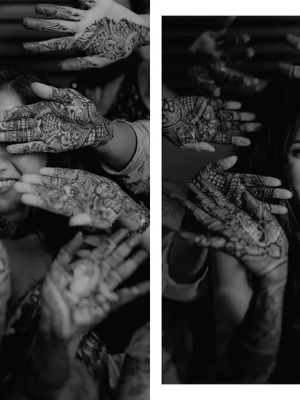 The bride surrounded by her friends, all showing off their intricate henna designs. This black and white shot is full of smiles and captures the joy of the Mehendi ceremony.