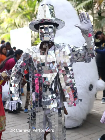 Our Mirror Man waves to the crowd, a friendly and futuristic character ready to interact with guests and bring a unique energy to any gathering.