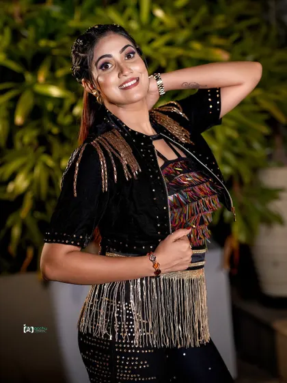 A smiling, happy shot that shows the fun side of a fashion-forward look. It proves that even edgy outfits can be styled for a joyful and approachable portrait.