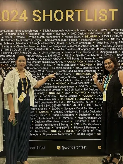 Our team at the World Architecture Festival in Singapore, proudly pointing out our firm's name on the 2024 Shortlist wall. It's a surreal moment to see our work recognized among the world's best.