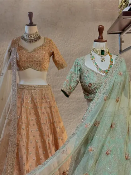 The pairing of a peach and mint lehenga shows how I can style a bridal party with coordinated yet distinct looks. Both feature intricate floral embroidery and flattering silhouettes.
