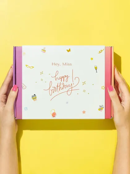 A simple and effective shot that highlights the gift box. Using a hand model and a bright, solid-color background keeps the focus entirely on the beautiful packaging.