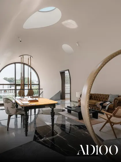 A living room with a vaulted ceiling and unique skylights, as featured in AD100.