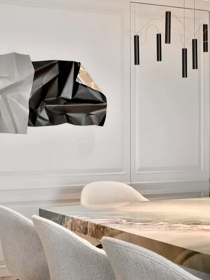 A closer view of the dining space, showing the harmony between my sculpture, the modern light fixture, and the elegant chairs.